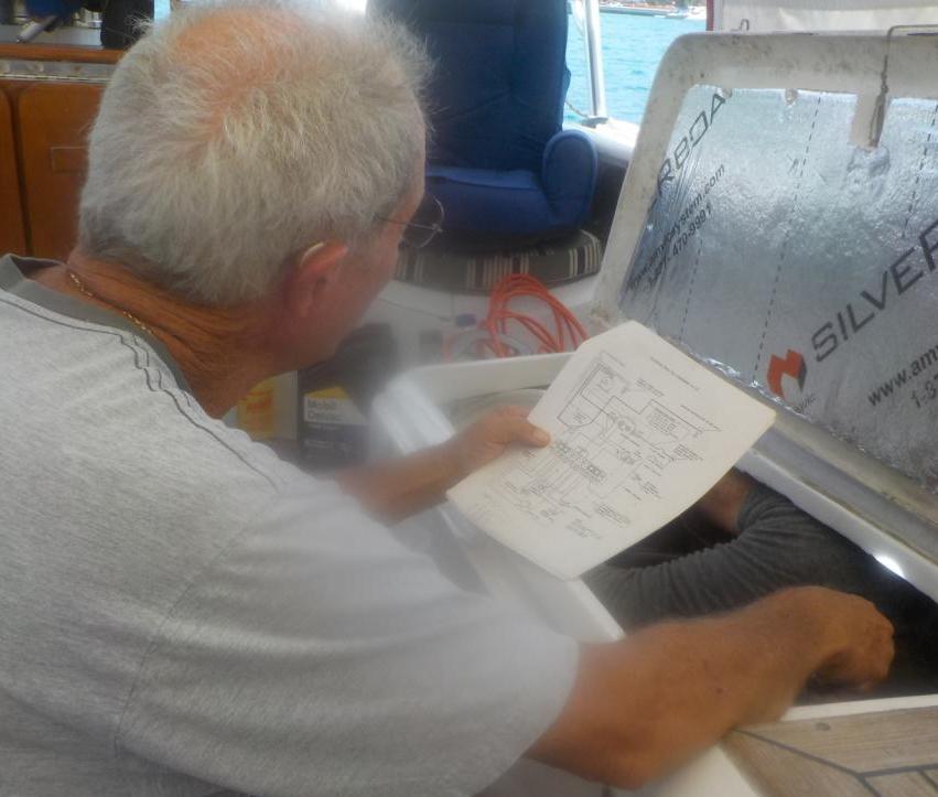 Grown men reading circuit diagram.JPG
