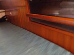 Starboard Quarter berth looking forward bookshelf and engine access door.JPG