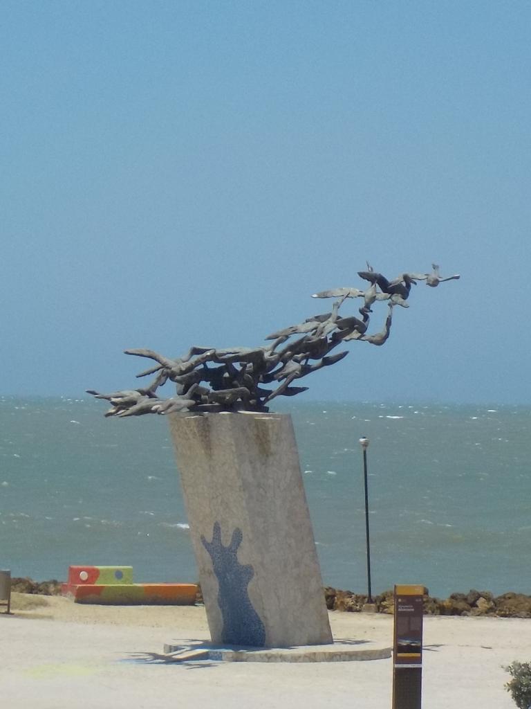 Flockof pelicans taking flight sculpture Santa Maria.jpeg