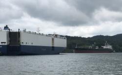 Two very large ship passing in narrow waterway.jpeg